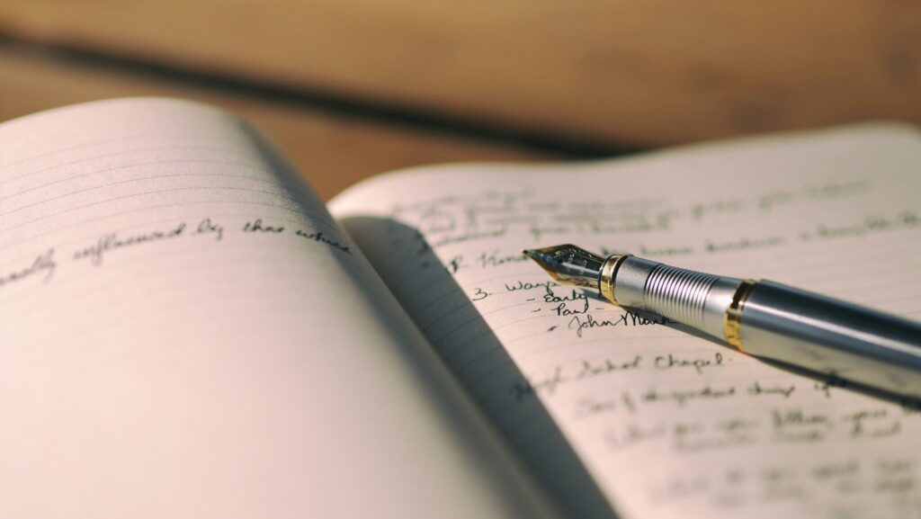 pen on white lined paper selective focus photography